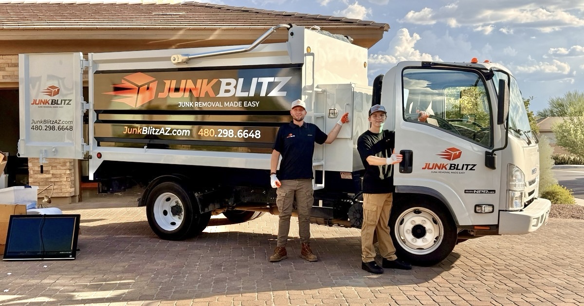 Kip and a JunkBlitz team member beside the JunkBlitz junk removal truck.